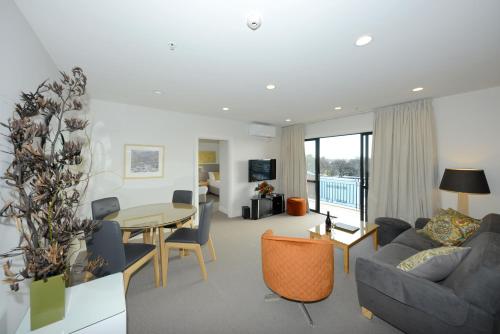 a living room with a couch and a table at West Fitzroy Apartments in Christchurch