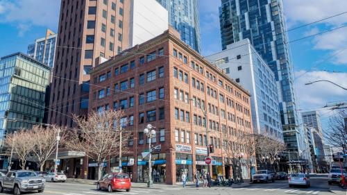 a large brick building in a city with tall buildings at Reside Seattle Downtown, a Wyndham Residence in Seattle