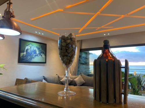 a bottle of wine and a wine glass on a table at PRESTIGIA ESSAOUIRA MOGADOR Luxury Ocean View in Essaouira