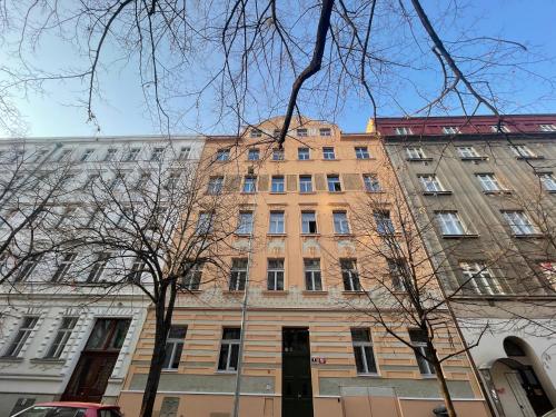 a tall brick building on a city street at Hidden Art Boutique Residence by Dwellfort in Prague