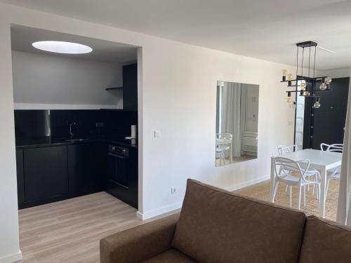 a living room with a couch and a table at CITY STAYS BELÉM APARTMENTS in Lisbon