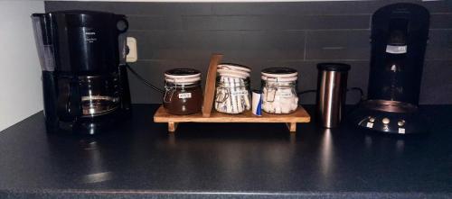 a counter top with a group of jars on a table at 't Brugske in Deurne