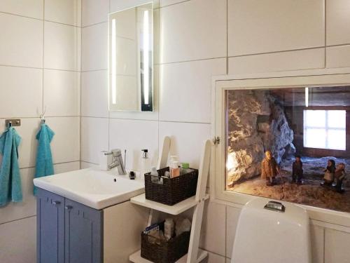 a bathroom with a sink and a stone wall at 4 person holiday home in SLITE in Slite