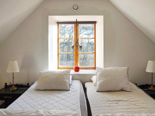 a bedroom with two beds in front of a window at 4 person holiday home in SLITE in Slite