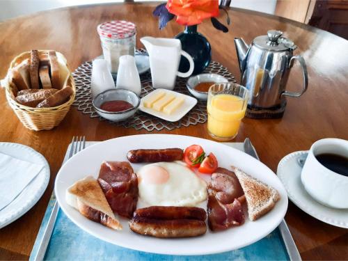 a plate of breakfast food with sausage and eggs on a table at Inveraray Farm in Beaufort