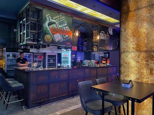 a bar with a table and chairs in a restaurant at Elan Luxury Apartments & Rooms in Plav
