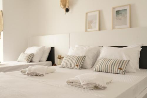 a white bed with two pillows on top of it at Blue Island Luxury Hotel Adults Only in Kas