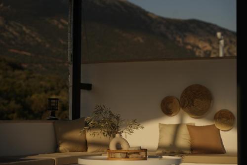 a living room with a couch and pillows on a wall at Blue Island Luxury Hotel Adults Only in Kas