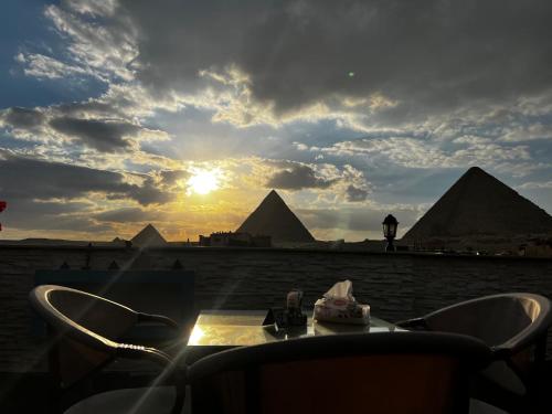 a view of the pyramids of giza at sunset at Pyramids top success result in Cairo