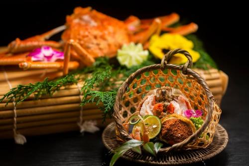 a basket filled with food on top of a table at Kawaguchiya Kinosaki Riverside Hotel in Toyooka