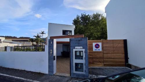 a building with a phone booth next to a fence at Atlantic Valley in Furnas