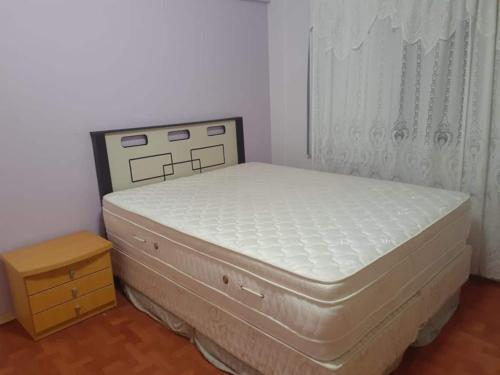 a bed in a bedroom with a white mattress at Ape agradável a 50 m das piscinas de Piratuba in Piratuba