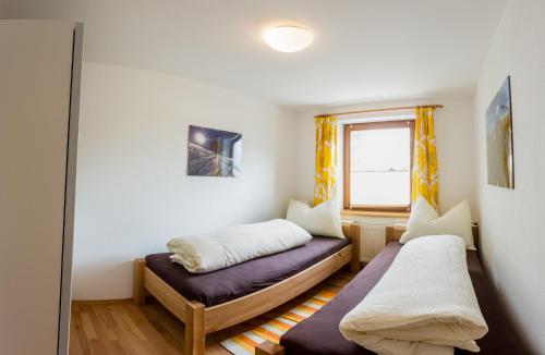a room with two beds and a window at Apartement Gute Laune in Mieming