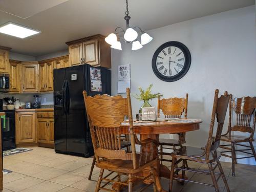 a kitchen with a table and a clock on the wall at The Tuscan Lodge in Payson
