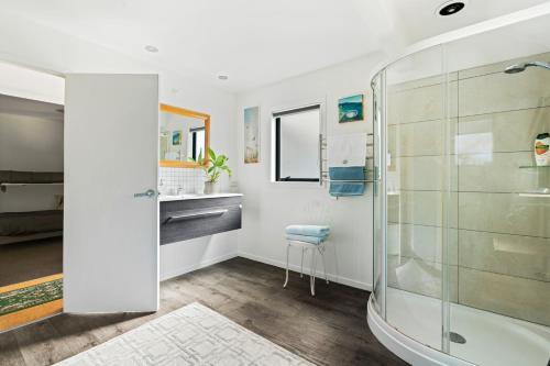 a bathroom with a shower and a sink at The Maples - Clyde Holiday Home in Clyde