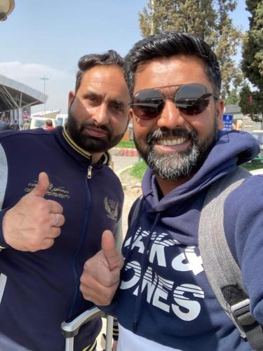 two men giving a thumbs up while standing next to each other at Hotel Jannat in Srinagar