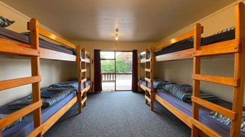 a room with four bunk beds in a room at National Park Backpackers in National Park