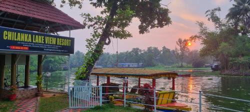 a boat in the water next to a building at Chilanka Lake View Resort in Alleppey