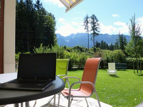 a laptop computer sitting on a table on a patio at Appartement-Pension Familie Gewessler in Bad Mitterndorf