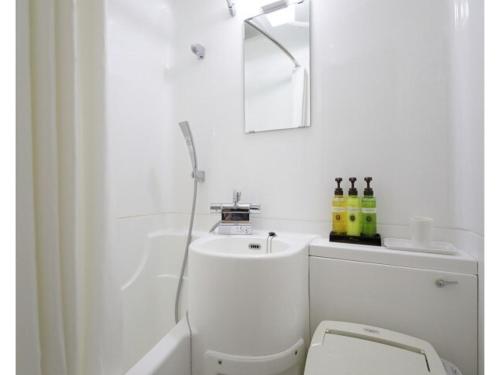 a white bathroom with a toilet and a sink at Tokyo Inn - Vacation STAY 11102v in Tokyo