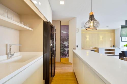 a kitchen with white countertops and a sink at Energy 801 in Medellín