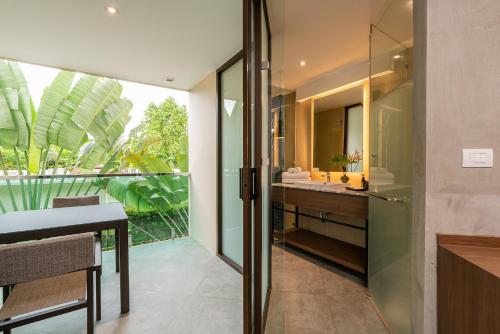 a bathroom with a sink and a mirror at Dewa Phuket Resort & Villas, Nai Yang Beach in Nai Yang Beach