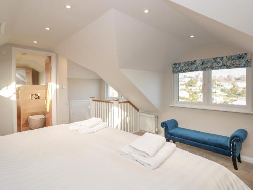 a bedroom with a large white bed and a window at Windwhistle in Dartmouth