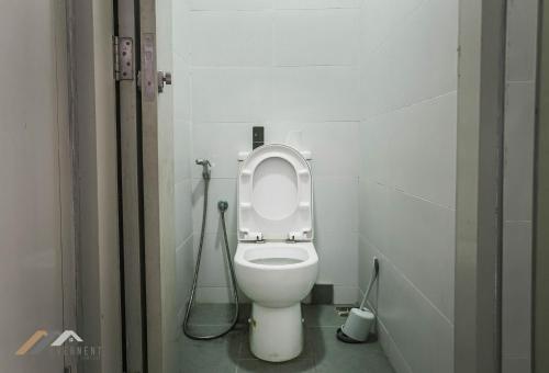 a bathroom with a toilet in a stall at Marina Times Square Homestay by Evernent in Miri