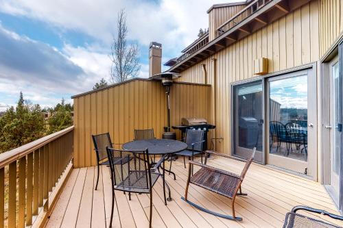 a patio with a table and chairs on a deck at Riverside R&R in Redmond