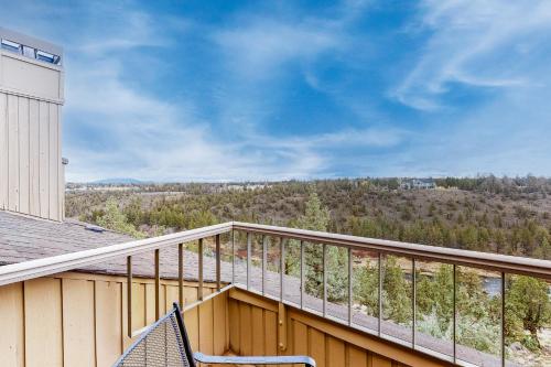 a balcony with a wooden railing next to a building at Riverside R&R in Redmond
