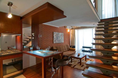 a kitchen and living room with a spiral staircase at Park Plaza Apart Hotel in Santiago