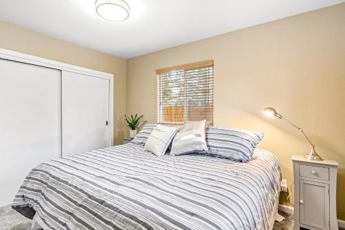 a bedroom with a bed and a window at Bungalow on Boyd in Coeur d'Alene