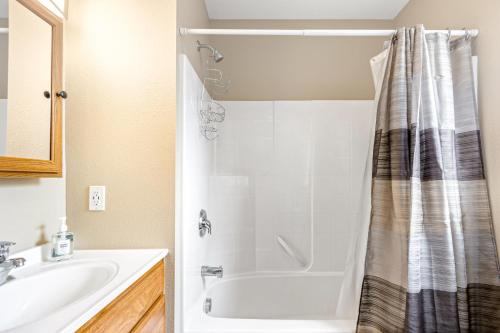 a bathroom with a tub and a sink and a shower at Bungalow on Boyd in Coeur d'Alene