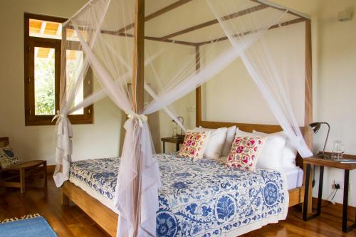 Boundary House في غالي: غرفة نوم بسرير مع مظلة