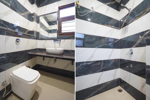 a bathroom with a toilet and a sink at FabHotel HC Mohali Inn in Kharar