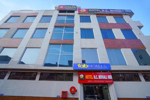 a tall building with a sign on top of it at FabHotel HC Mohali Inn in Kharar