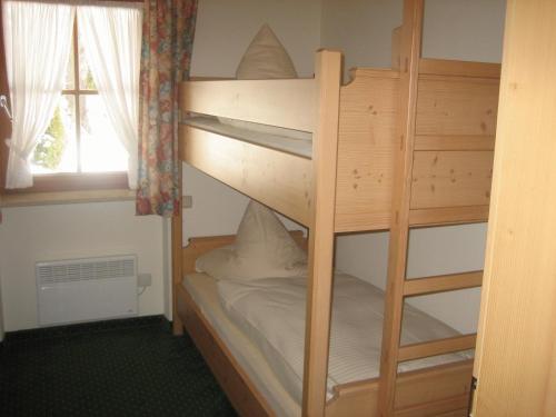 a couple of bunk beds in a room with a window at Sonnenkaiser in Fischbachau