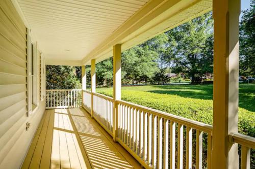a porch of a house with a view of a field at La Maison des Ours in Earlysville