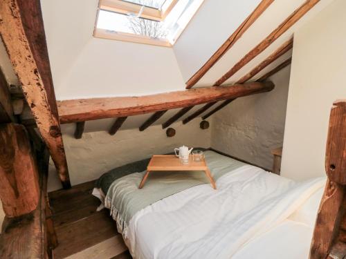 a small room with a bed and a table at The Potting Shed in Scarborough