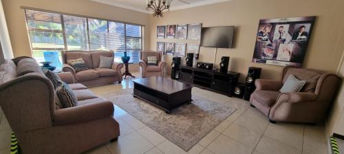 a living room with couches and a coffee table at Heimat Guesthouse in Welkom