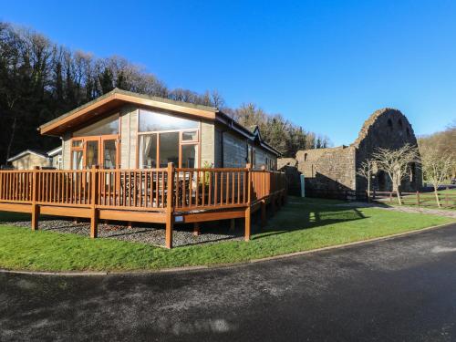 a house with a large deck on the side of the road at Seventh Heaven in Narberth