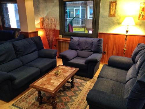 a living room with couches and a coffee table at Hotel Casado in Pas de la Casa