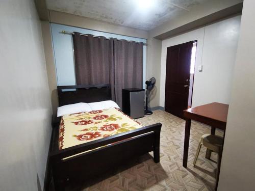 a bedroom with a bed and a desk and a desk at BAGUIO Betty's Room Rental Couple Studio in Baguio