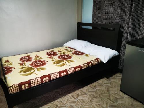 a bedroom with a bed with a bedspread with flowers on it at BAGUIO Betty's Room Rental Couple Studio in Baguio