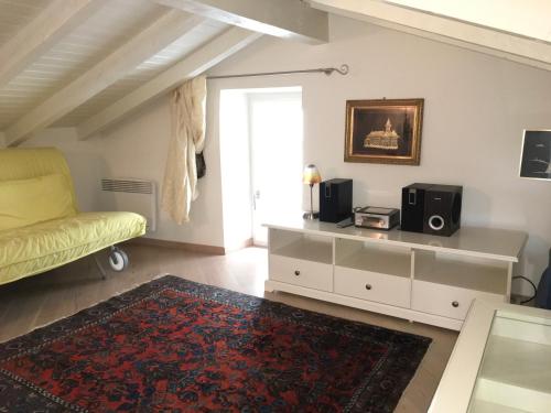 a living room with a yellow couch and a tv at Ferienhaus, Rustico Auf Burg in Locarno