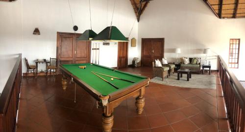 a pool table in the middle of a living room at Kruger Private Lodge in Marloth Park
