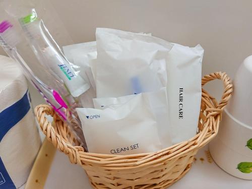 a basket filled with toothbrushes and toothpaste at Meguminoyu in Furano
