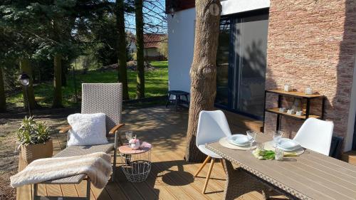 a wooden deck with a table and chairs on it at Vila EVIO Třeboň in Třeboň