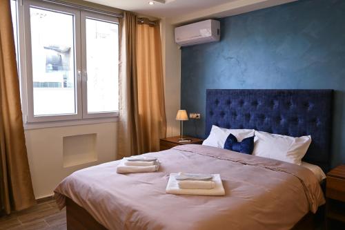 Un dormitorio con una cama grande con toallas. en Acropolis of Athens from Ermou str, en Atenas