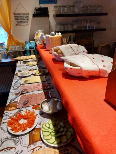 a long table with plates of food on it at Penzion Lipno Jantar in Horní Planá